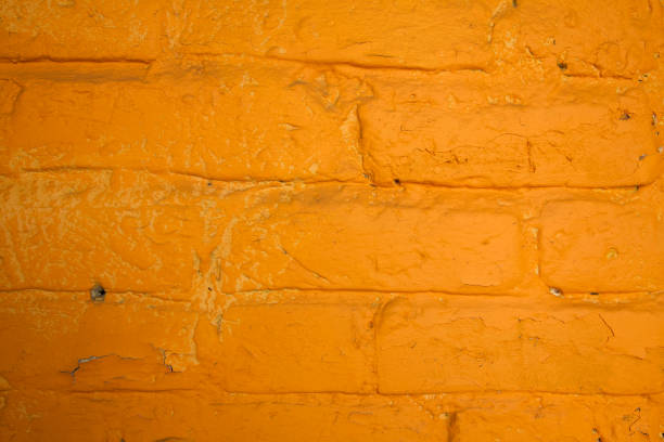 istock Old painted brick wall of orange color 1255546649