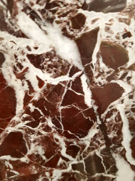 istock Dark soft, textured marble background. Dark maroon with white stripes background . 1255549864