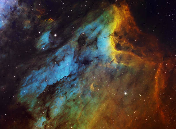 The PelicanNebula (IC 5070) in the constellation of Cygnus, HST image The Pelican Nebula (IC 5070) is the large hydrogen, sulfur and oxygen gas cloud in the constellation of Cygnus. The light from young energetic stars is transforming cold gas to hot and causing an effect of ionization. The nebula is 2,000 light years away from Earth. Amateur image consists of: Ha: 53 x 900s, OIII: 53 x 900s, SII: 55 x 900s. Total exposure time: 40h15m, HST palette image. hubble space telescope photos stock pictures, royalty-free photos & images