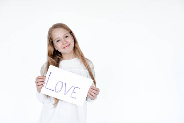 istock Little girl with a picture on a white background. 1255554504