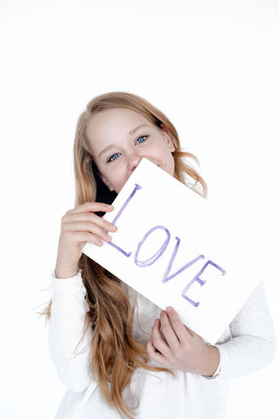 istock Little girl with a picture on a white background. 1255554698
