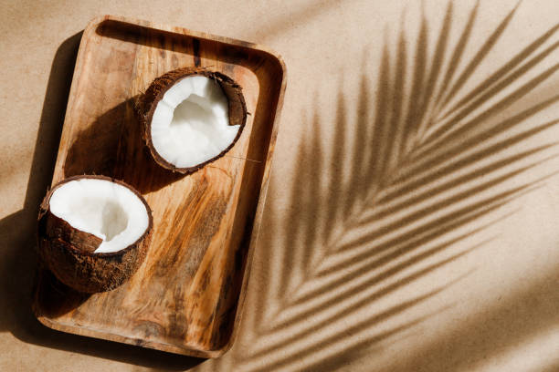 istock Summer abstract creative composition with coconut a on wooden tray over kraft paper. 1255555948