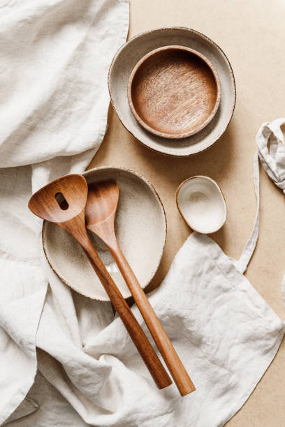 istock Modern minimalist ceramics set with a linen cloth over kraft paper background. Natural products or food concept, top view, flat lay. 1255555949