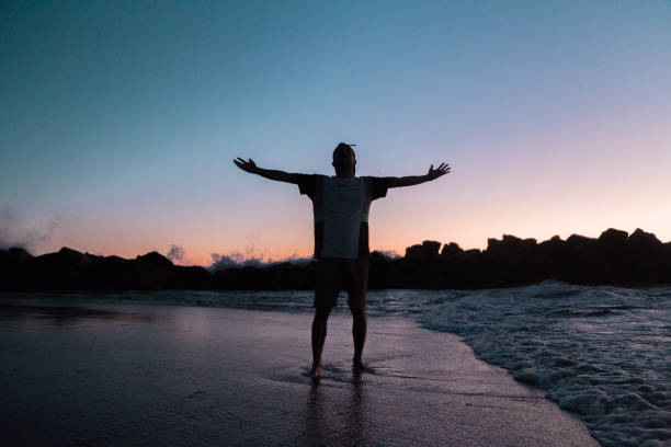 istock Man in a sunset in the beach. 1255557062