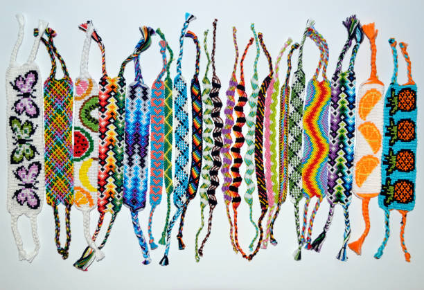 istock Woven friendship bracelets with alpha and normal patterns handmade of thread on white background 1255558348