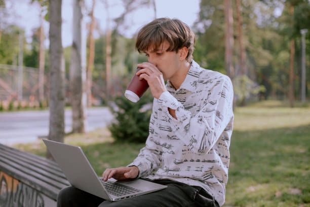 istock Satisfied businessman relaxing outdoor while drinking a mug of coffee 1255559323