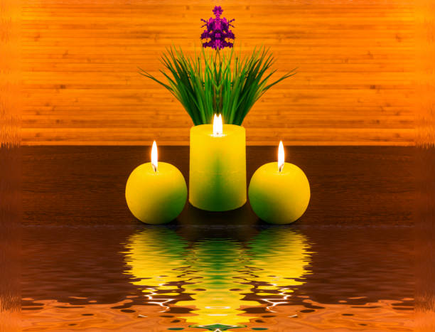 Candle with Oriental coin on pebbles with bamboo background.click below for other candle images.