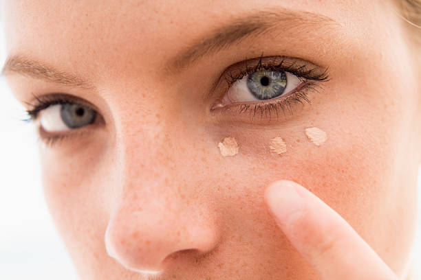 Woman applying concealer  concealer stock pictures, royalty-free photos & images
