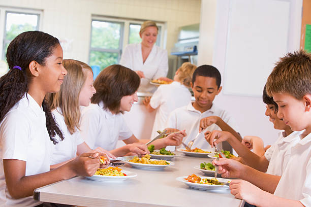 istock Schoolchildren enjoying their lunch in a school cafeteria 125556169