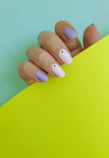 istock female hand beautiful manicure on color background 1255562579