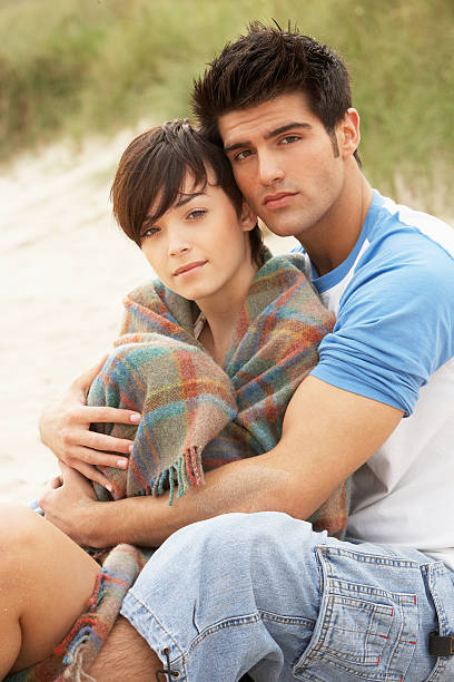 istock Romantic Young Couple Embracing On Beach 125556334