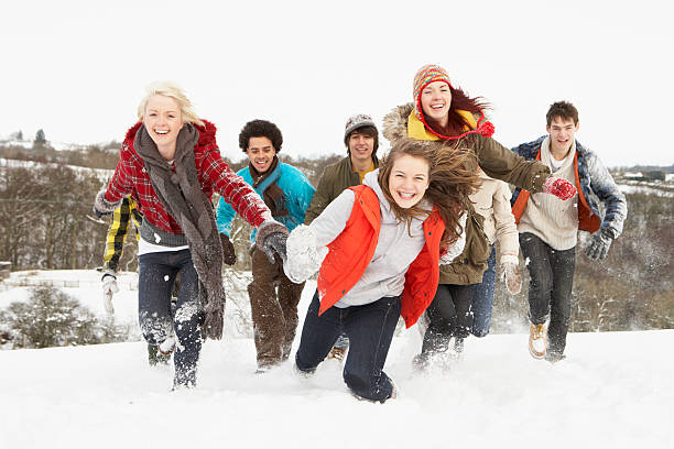 Teenage Friends Having Fun In Snow stock photo