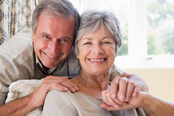 istock Couple relaxing in living room smiling 125556471