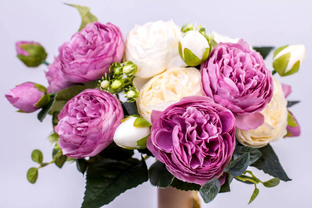 istock white and purple peonies in a vase on a gray background 1255565241