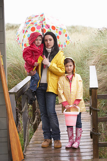 istock Sad mother and children on beach 125556579