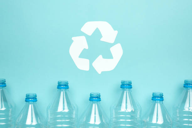 istock Clear plastic bottles without caps on a blue background. Recycling and environment concept. 1255565891