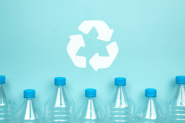 istock Clear plastic bottles with caps on a blue background. Recycling and environment concept. 1255565892