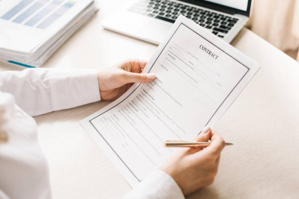 istock reads a contract and holds a metal pen 1255566691