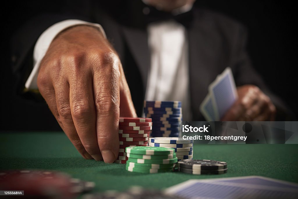 card player gambling in casino card player gambling casino chips on green felt background selective focus Poker - Card Game Stock Photo