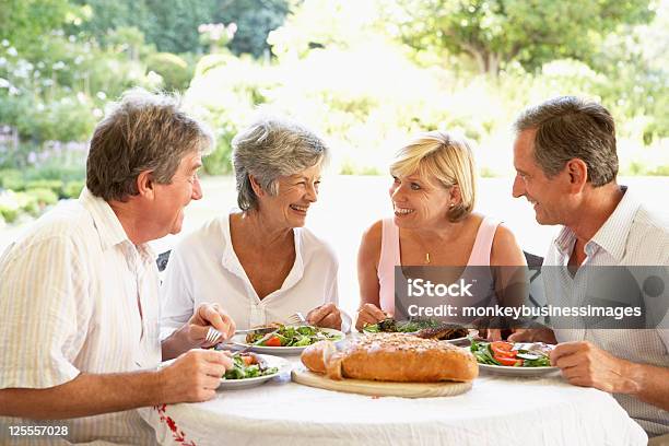 Friends Eating An Al Fresco Lunch Stock Photo - Download Image Now - Meal, Senior Adult, Mature Adult