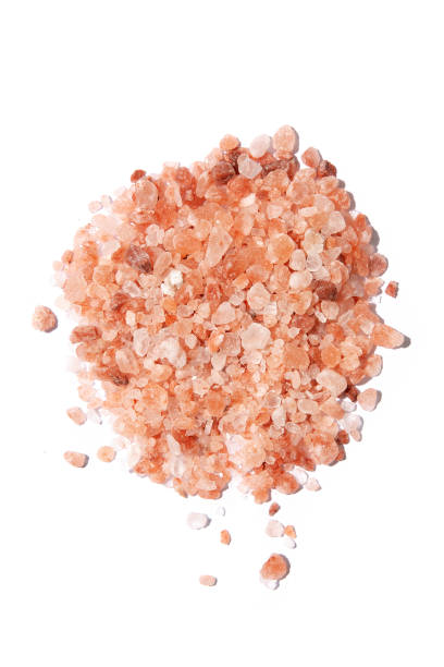 istock Loose Himalayan pink rock salt against white background 1255573058