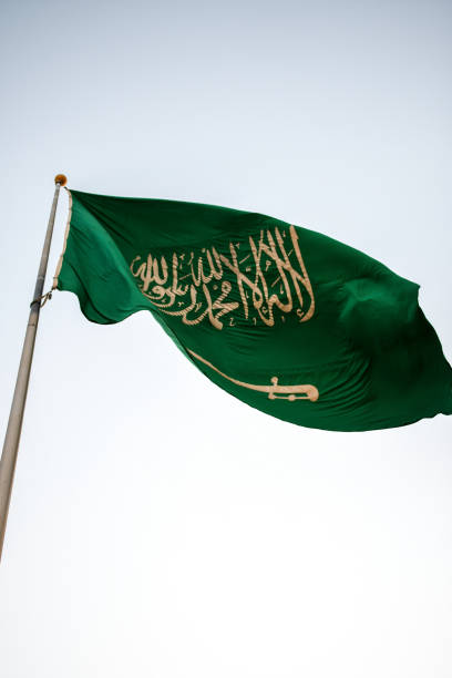 istock Saudi Arabia National Flag waving in the sky 1255573599
