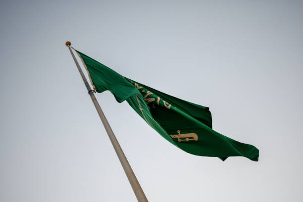 istock Saudi Arabia National Flag waving in the sky 1255573600
