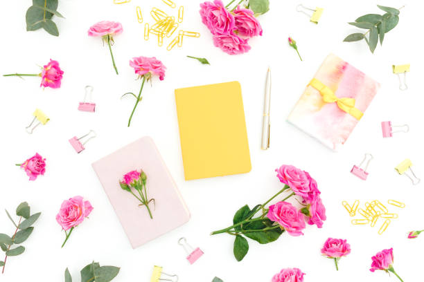 istock Frame composition with notebook, eucalyptus, gift and roses on white background. Flat lay. Top view 1255575599