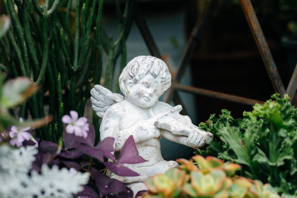 Little angel playing the violin among the flowers Little angel playing the violin among the flowers winged cherub stock pictures, royalty-free photos & images