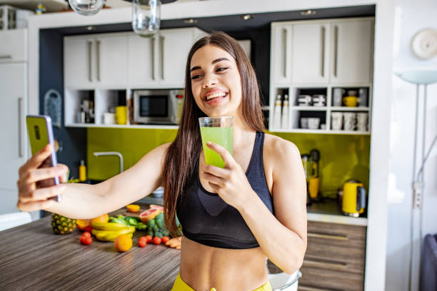 istock Young active woman taking a selfie in the kitchen 1255579224