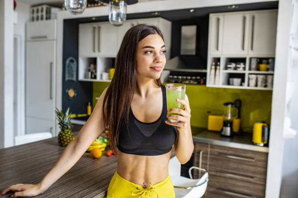 istock Young active woman holding healthy smoothie 1255579233