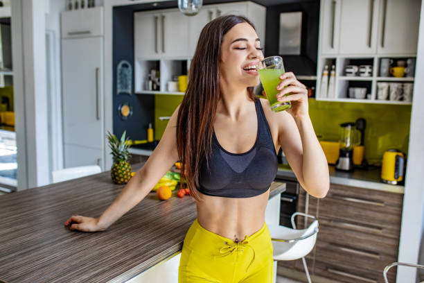 istock Young active woman drinking healthy smoothie 1255579268