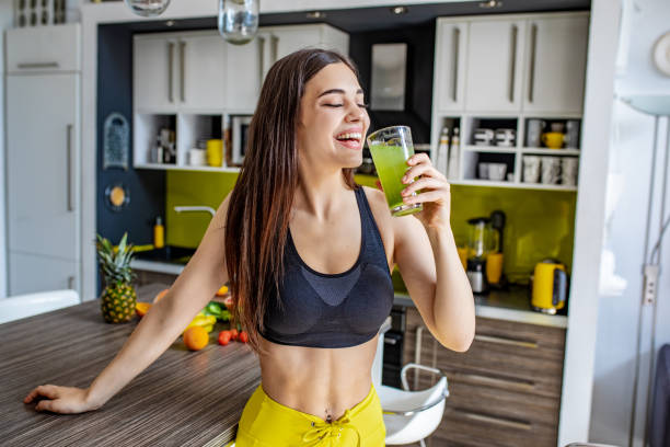 istock Young active woman drinking healthy smoothie 1255579303