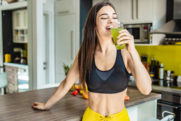 istock Young active woman drinking healthy smoothie 1255579344