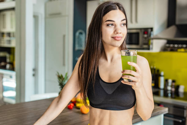 Young active woman holding healthy smoothie