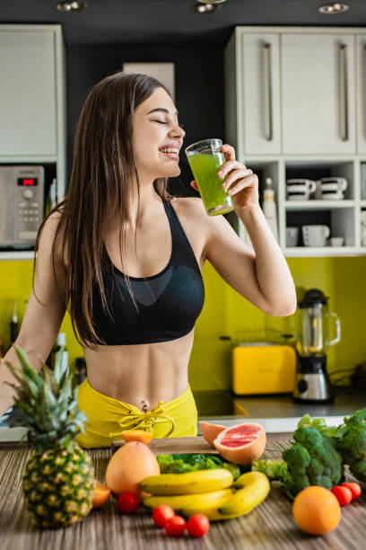 istock Young active woman drinking healthy smoothie 1255579398