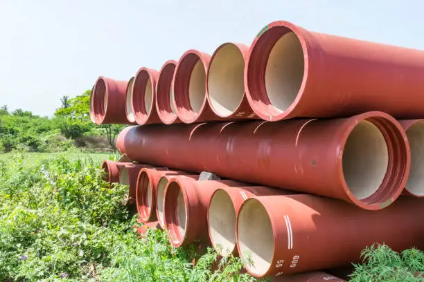 close view of ductile iron pipe kept on open field for making new construction.