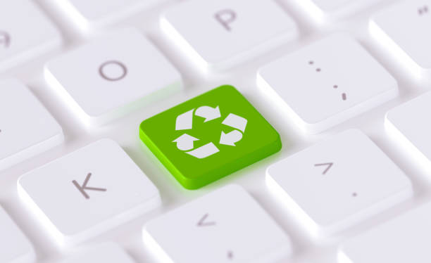 High quality 3d render of a modern keyboard with recycle symbol drawn green button. Horizontal composition with copy space. Recycling concept.
