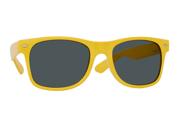 istock Sunglasses with a yellow plastic frame and black lenses isolated on white background. 1255581521