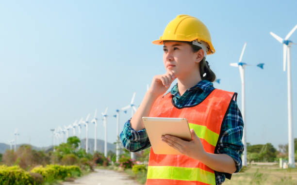 istock Engineering Asian woman is checking wind turbine Renewable energy concepts 1255582670