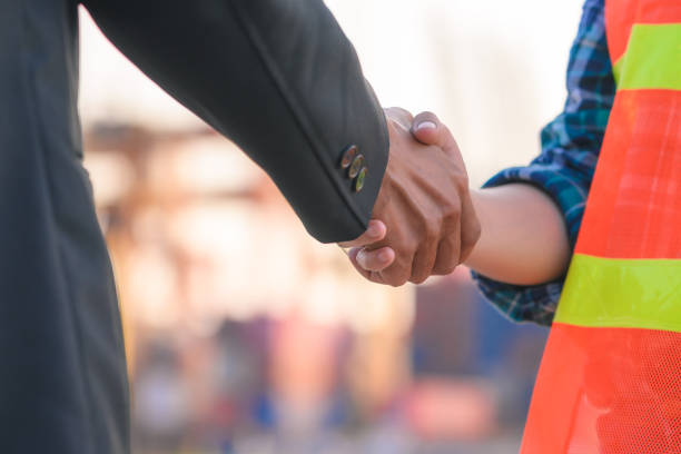 istock Engineering joins hand in business in industrial port background 1255582708