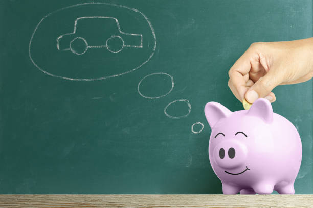 istock human hand dropping a coin into white piggy bank 1255582835