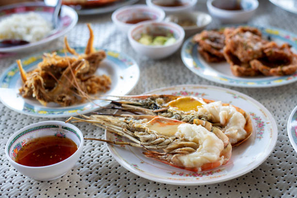 istock Grilled giant freshwater prawn in selective focus with other spicy dishes prepare for sharing to all in table lunch 1255582995