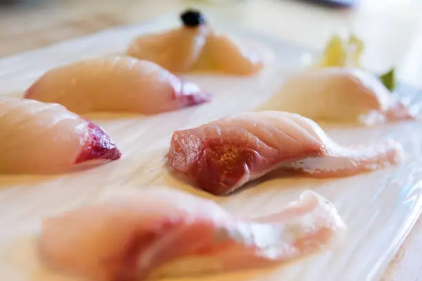 Premium nigiri sushi - scallop , kanpachi , red seabream , aburi hotate , hamachi , yellow tail , madai