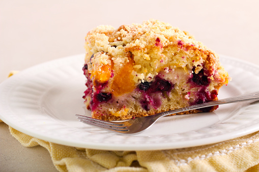 Fruit and berry cake with crumble topping, called buckle, served