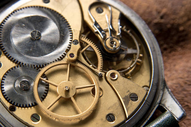 istock Golden Clockwork details, pinions and wheels closeup 1255585011