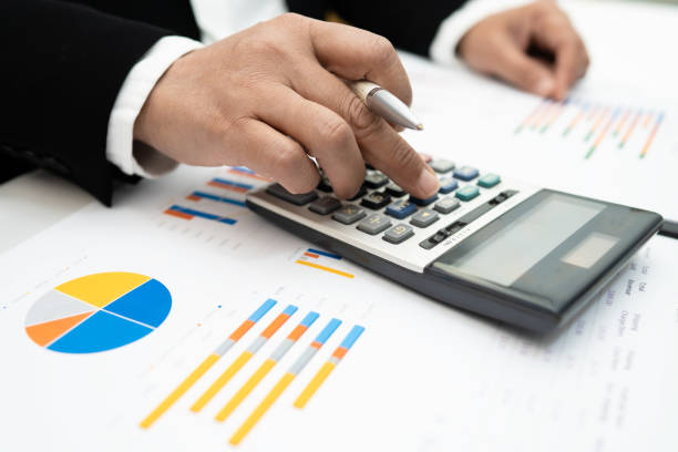 istock Asian accountant working and analyzing financial reports project accounting with chart graph and calculator in modern office,finance and business concept. 1255585230