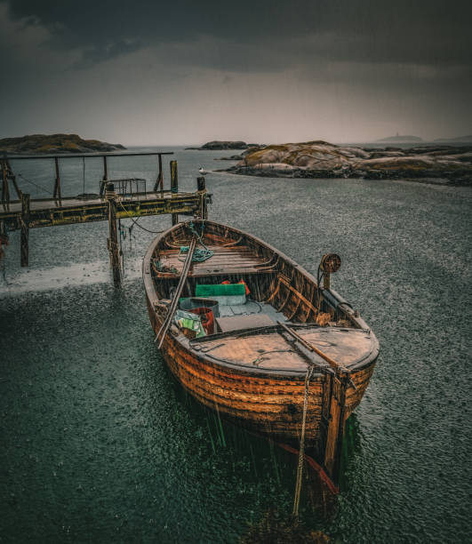 An old fishingboat in rain at Tjurpannan, Northern Bohuslan, Sweden