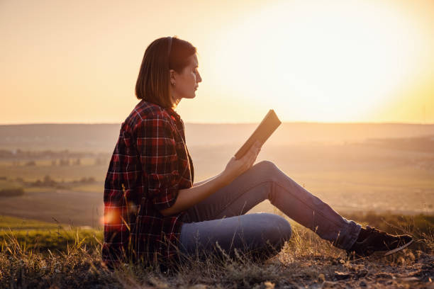 istock beautiful woman writing into her diary, in the park 1255585423