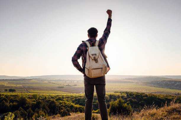 istock Silhouette of a champion on mountain peak. Active life concept 1255585470